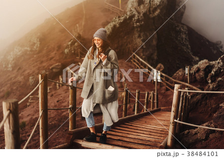 Girl climbs the path to the mountain Girl climbs the path to the mountain 38484101