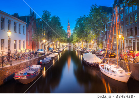 River, traditional old houses and boats, Amsterdam 38484387