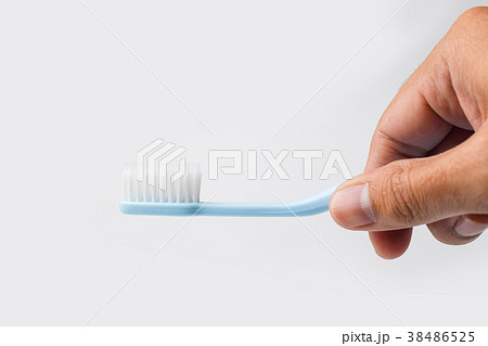 hand holding toothbrush on white background 38486525
