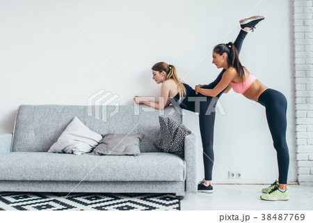 Fit girls preparing legs workout. Leg stretching Fit girls preparing legs workout. Leg stretching 38487769