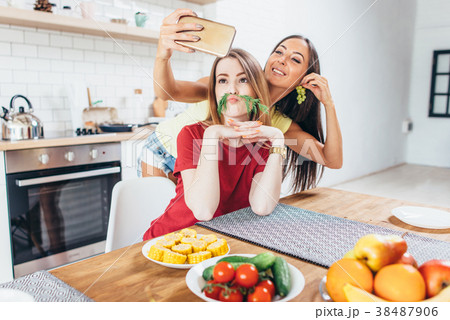 Women preparing food playing with vegetables in 38487906