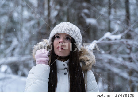 Beautiful girl with long dark hair in a white 38488109