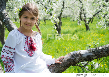 Cute girl dressed in embroidery in the garden 38489852