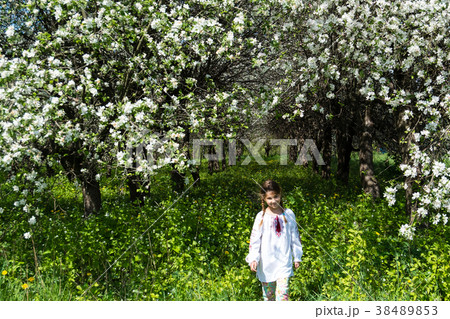 Cute girl dressed in embroidery in the garden Cute girl dressed in embroidery in the garden 38489853