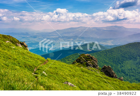 grassy hillside over the cliff in mountains 38490922