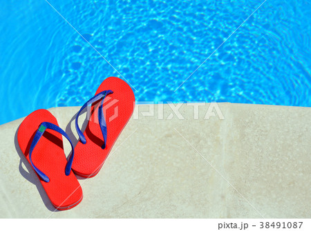 Pair of red flip-flops. 38491087