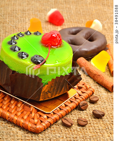 Cake in green jelly with cherry. Cake in green jelly with cherry. 38491088