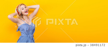 Blonde girl in blue striped blouse with headphones 38491172