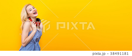 Blonde girl in blue striped blouse with headphones 38491181