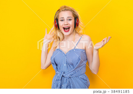 Blonde girl in blue striped blouse with headphones 38491185