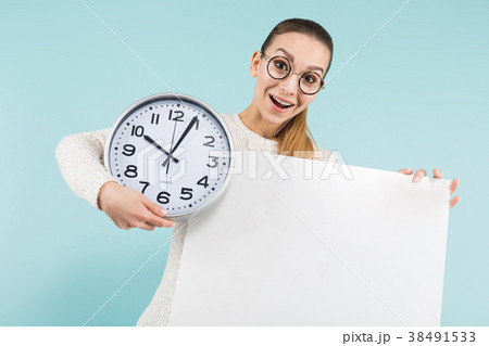 Attractive young woman with blank banner and clock Attractive young woman with blank banner and clock 38491533