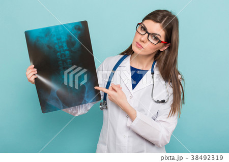 Female doctor in glasses with X-ray Female doctor in glasses with X-ray 38492319