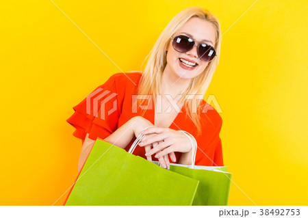 Blonde woman in dress with bags 38492753