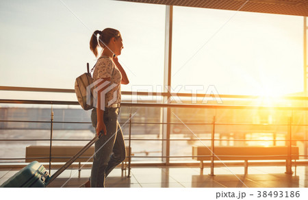 woman talking on phone waiting for flying at airport at window woman talking on phone waiting for flying at airport at window 38493186