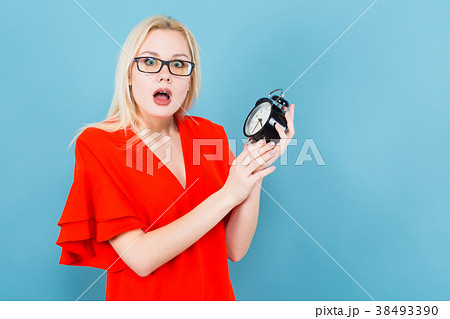 Blonde woman holding alarm clock 38493390