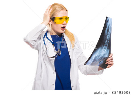 Surprised woman doctor in white coat with X-ray Surprised woman doctor in white coat with X-ray 38493603