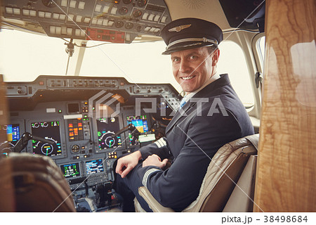 Happy pilot locating in cabin 38498684
