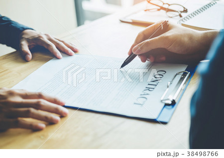 Business people negotiating a contract between 38498766