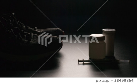 DOPING: Plastic containers, syringe and sport shoe DOPING: Plastic containers, syringe and sport shoe 38499864