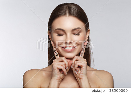 Affectionate young woman showing fingers with Affectionate young woman showing fingers with 38500099