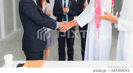 Arabian and Asian businessmen handshake Arabian and Asian businessmen handshake 38500642
