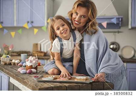 Pleased lady and child showing their culinary 38500832