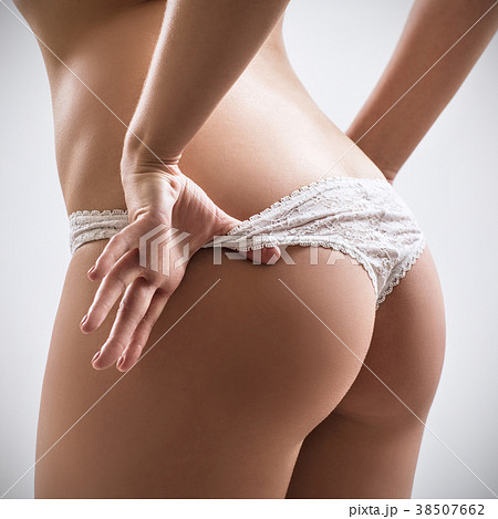 Sexy beautiful woman taking off her lace panties. - Stock Photo