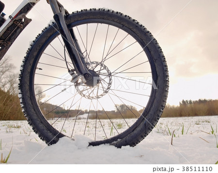 Front wheel of mountain bike while snow riding. Front wheel of mountain bike while snow riding. 38511110