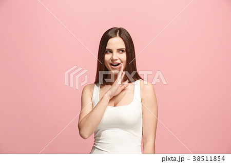 The young woman whispering a secret behind her 38511854