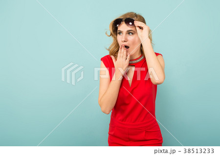 Shocked woman in red overalls and sunglasses Shocked woman in red overalls and sunglasses 38513233