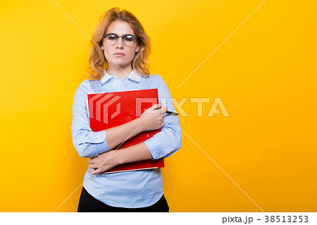 Unhappy woman with big folder Unhappy woman with big folder 38513253