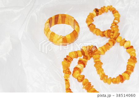 Amber necklace on a light background Amber necklace on a light background 38514060
