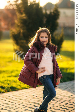 Little girl posing for photographer. Golden autumn Little girl posing for photographer. Golden autumn 38514339