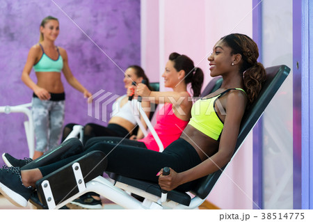 Young woman doing exercise for legs while 38514775