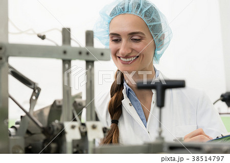 Portrait of happy woman technician checking 38514797