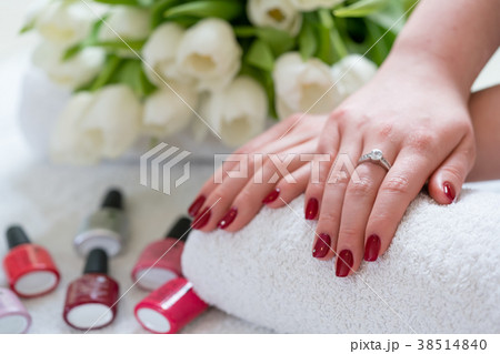 Close-up of the hands of a young woman with red Close-up of the hands of a young woman with red 38514840