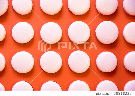 Pink macarons on orange background Pink macarons on orange background 38518223