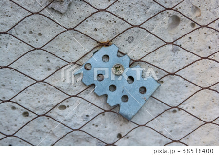 Piece of suspension on plaster wall close 38518400