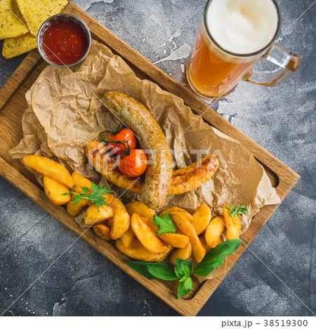 Grilled sausages with fried potatoes and tomato Grilled sausages with fried potatoes and tomato 38519300