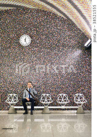 Mature businessman with smartphone in a metro Mature businessman with smartphone in a metro 38521555
