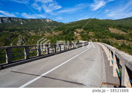 long road on the bridge in the mountains 38521666