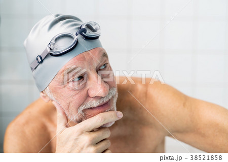 Portrait of a senior man in an indoor swimming 38521858