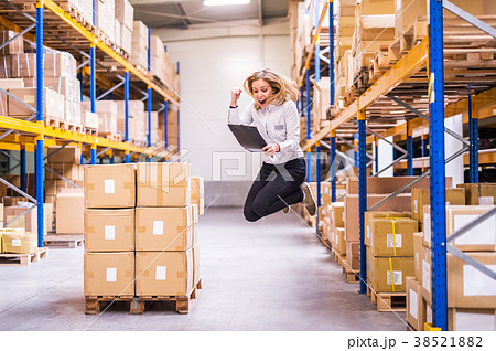 Overjoyed female worker or supervisor in a Overjoyed female worker or supervisor in a 38521882