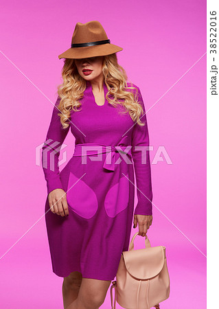 Beautiful blonde in a hat. Pink background. 38522016