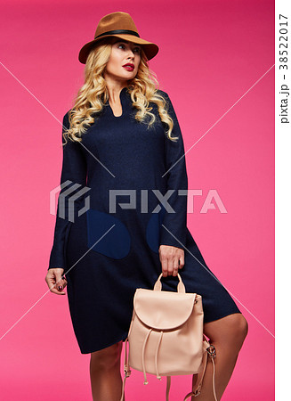 Beautiful blonde in a hat. Pink background. Beautiful blonde in a hat. Pink background. 38522017