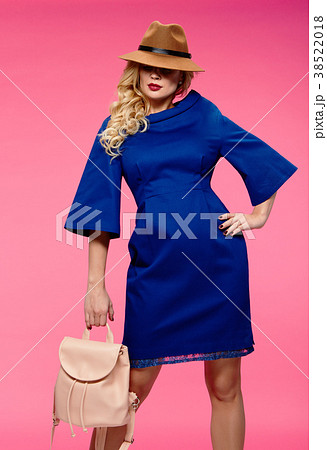 Beautiful blonde in a hat. Pink background. Beautiful blonde in a hat. Pink background. 38522018