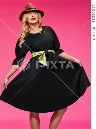 Beautiful blonde in a hat. Pink background. Beautiful blonde in a hat. Pink background. 38522019