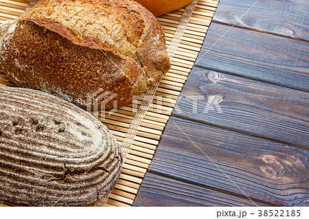 Assortment of baked bread on wooden table 38522185