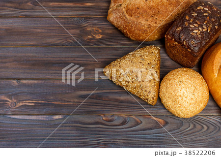 assortment of baked bread on wood table 38522206