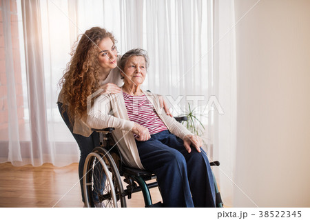 A teenage girl with grandmother at home. A teenage girl with grandmother at home. 38522345